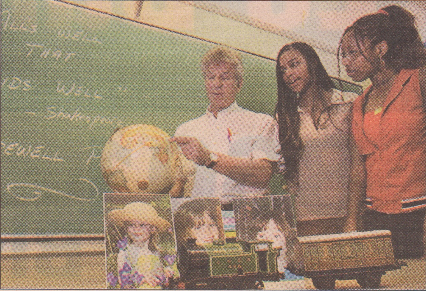 RICHARD ARLESS JR. THE GAZETTE English teacher Chris Eustace retires this month. He shows Pierrefonds Com-prehensive High School Grade 10 students Chandecia Walker (centre) and Vanessa Bryan where he was born in Africa.